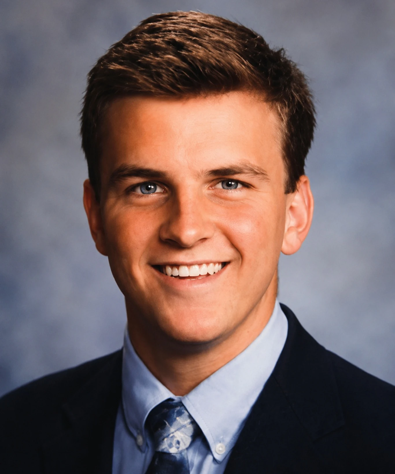 Professional headshot against blue background