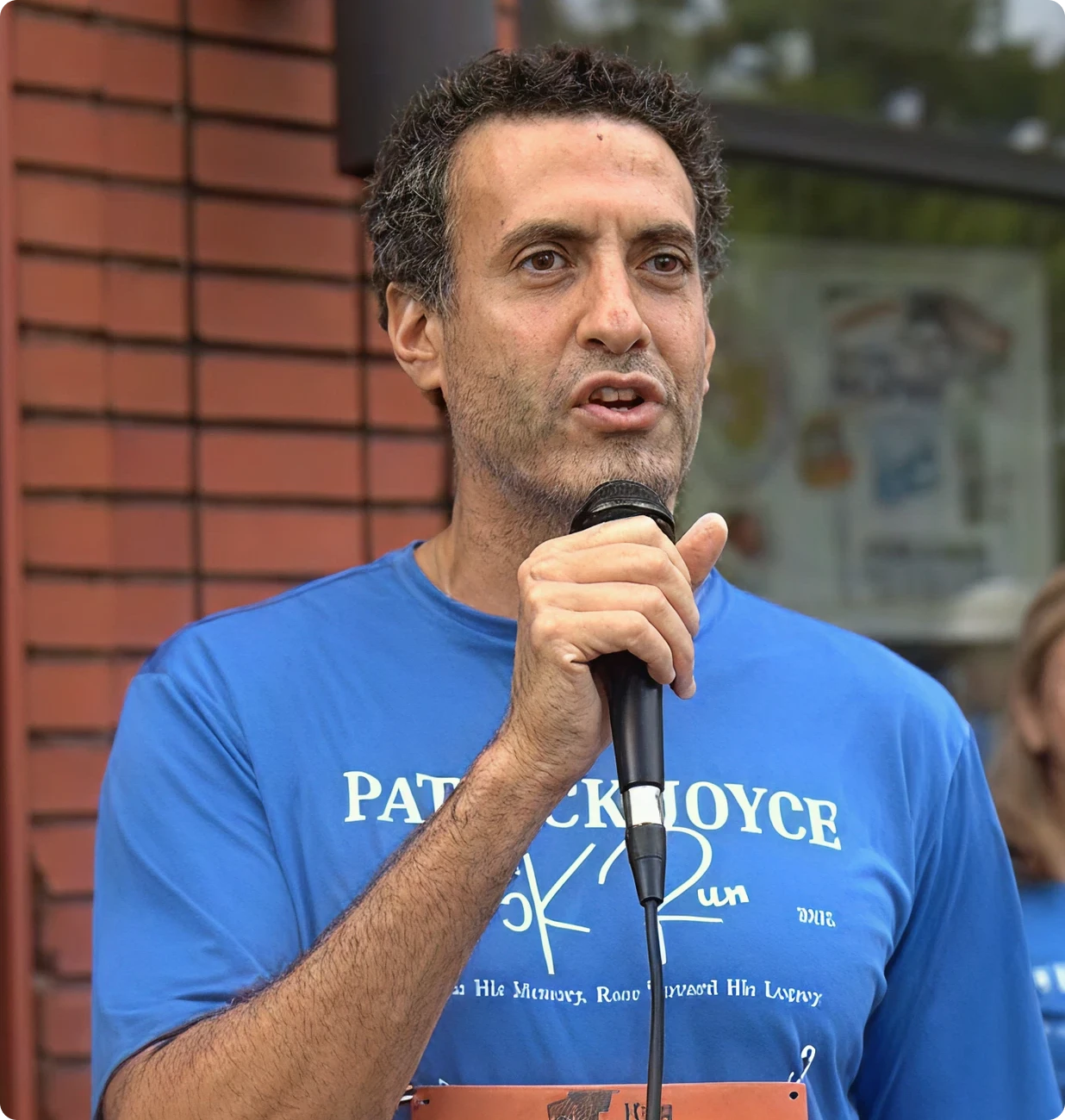Man speaking with microphone outdoors